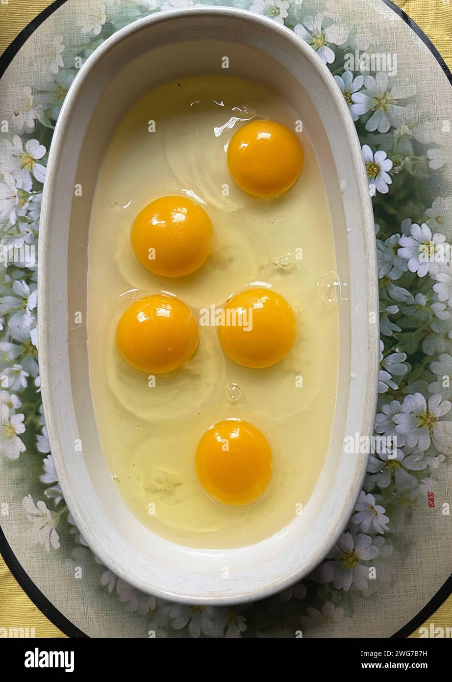 Chicken eggs in a bowl ready to be used in making a cake. Stock Photo