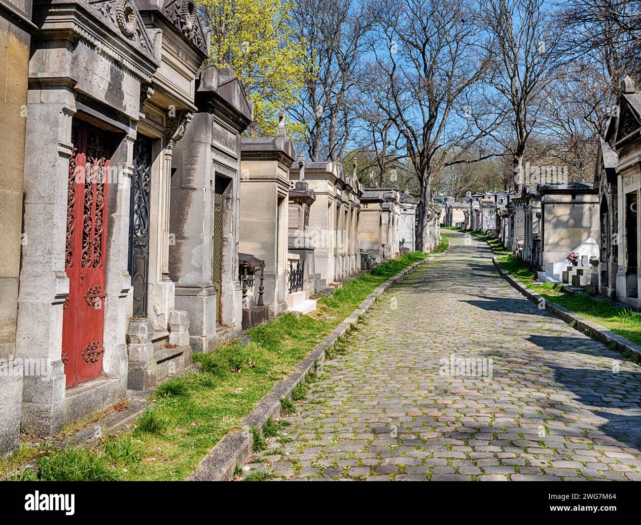 A red door marks an entrance to one of the crypts at the Pere Lachaise Cemetery in Paris. Stock Photo