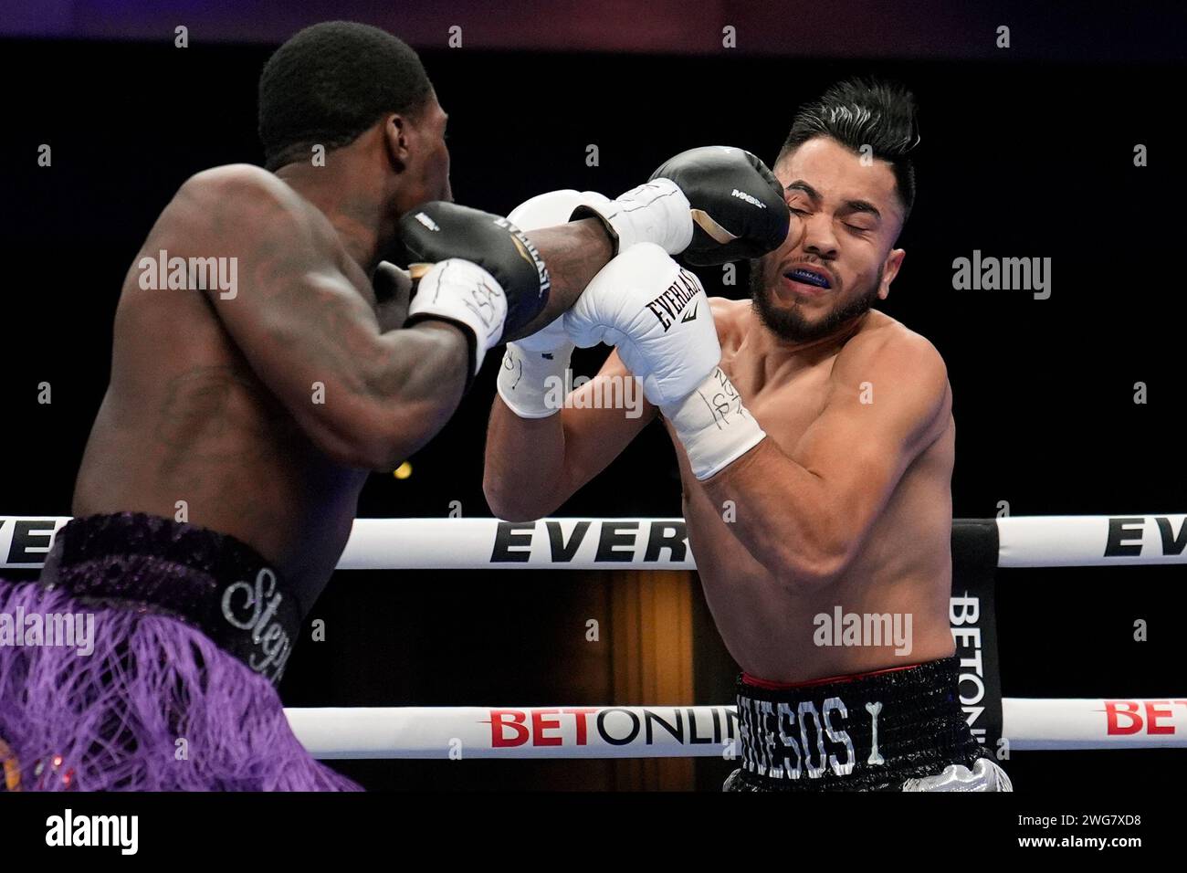 Khalil Coe hits Gerardo Osuna in a light heavyweight boxing match