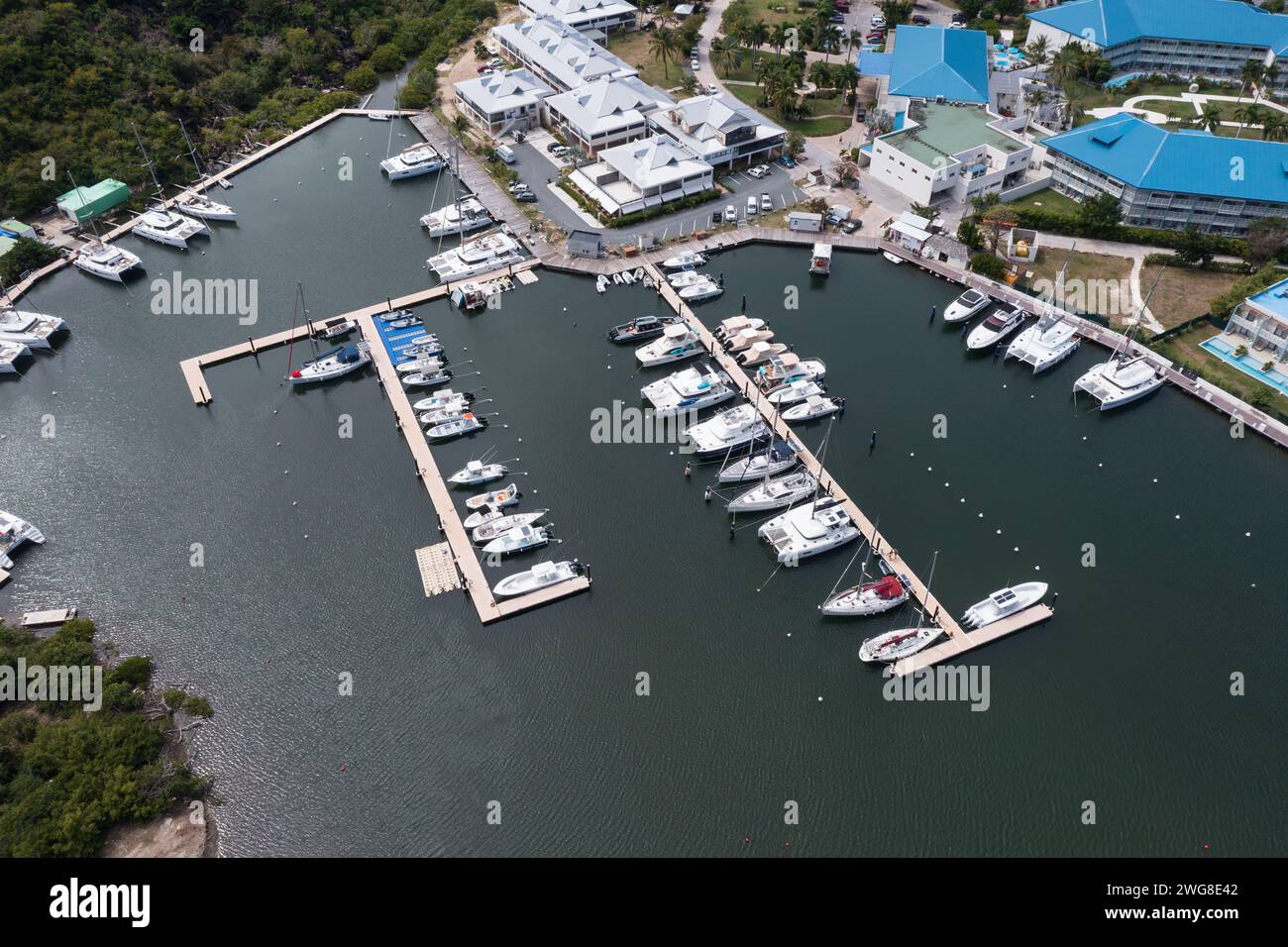 Aerial view of boats moored alongside an airport, reflecting a serene ...
