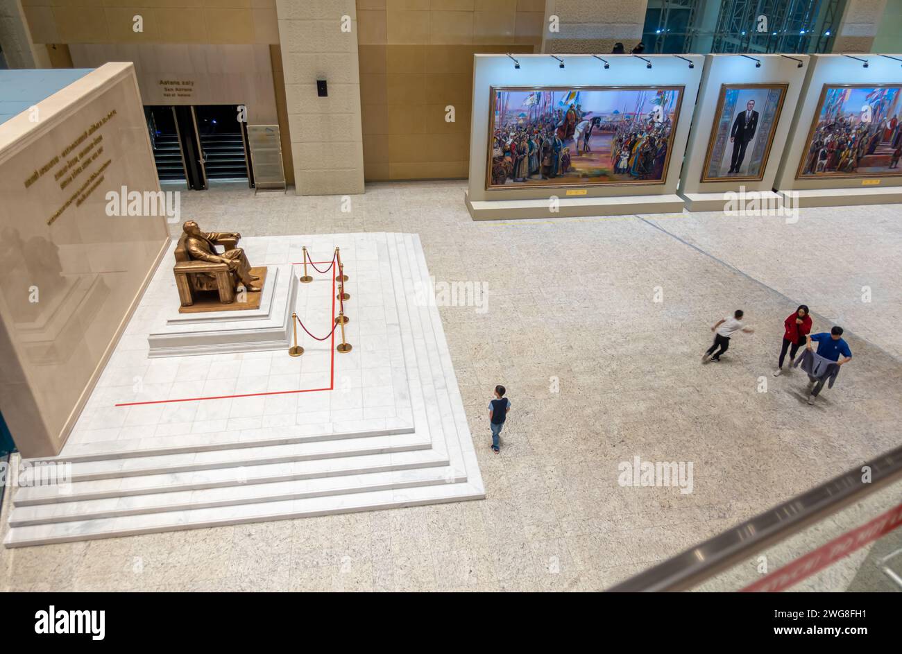 Visitors in National Museum of Kazakhstan, Astana in the main hall with the Nazarbaev statue Stock Photo