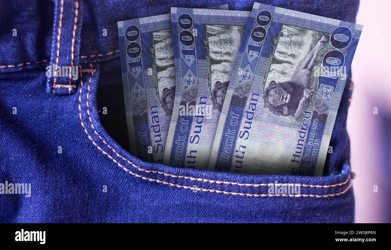 Bunch of South Sudan 100 Pounds banknotes in a jeans pocket a concept of spending Stock Photo