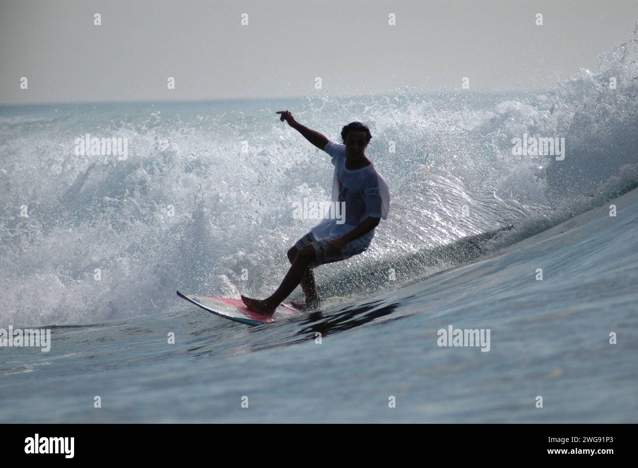 A man surfed between waves in Mentawai Island, West Sumatera, Indonesia Stock Photo