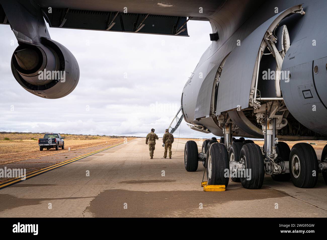 U.S. Air Force Senior Airman Joseph Szutyanyi, left, and Senior Airman Logan Buhk, electrical and environmental systems maintainers with the 22nd Airlift Squadron, preform preflight checks on a C-5M Super Galaxy during Winter Training for the Advanced Airlift Tactics Training Center, at Fort Huachuca, Arizona, January 24, 2024. Winter Training is a break from the regular course schedule where the instructors of AATTC tweak the training scenarios for the coming year and perform them, with the help of guest units, to keep their skills fresh. This is the first time that a C-5 has practiced tactic Stock Photo