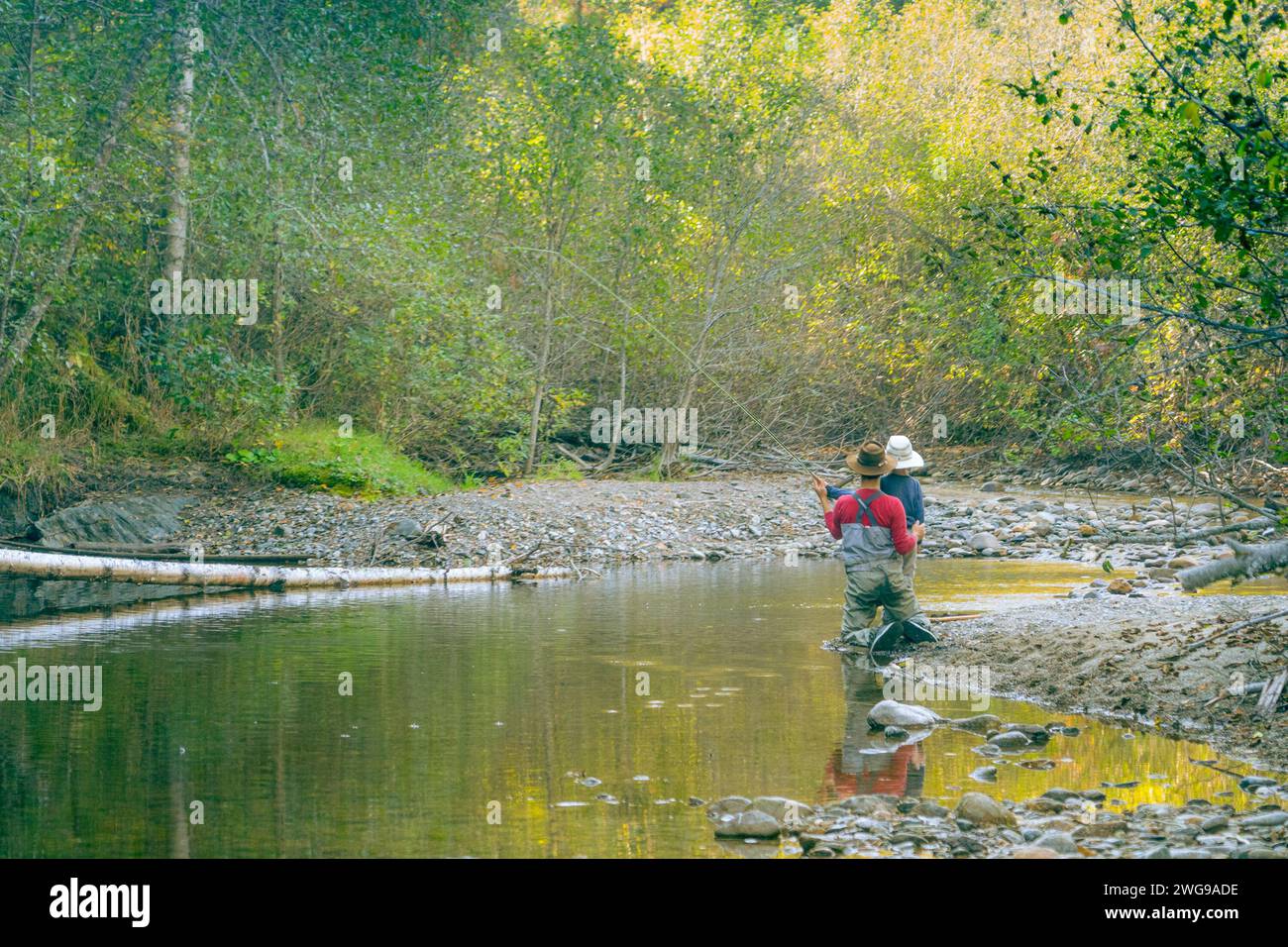 Man showing children how to fly fish in the afternoon. Stock Photo