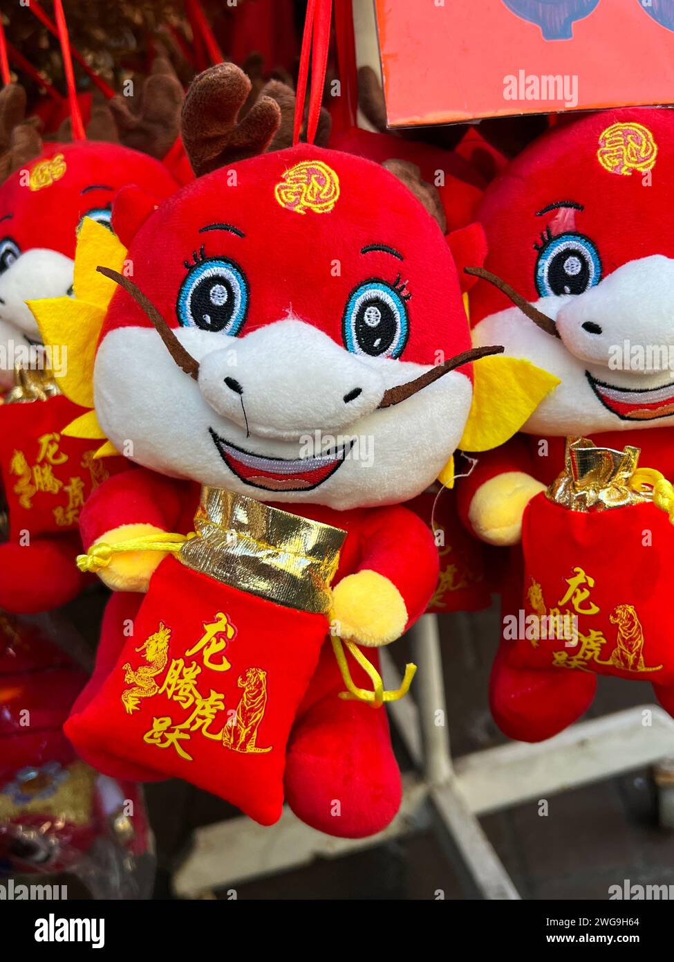Singapore, Jan 2024. Chinatown, preparation to the Chinese New Year, with bright red and gold cute dragons for sale. Stock Photo