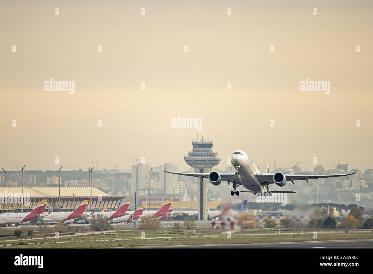 Airplane after boarding takeoff near the control tower heading to its destination Stock Photo