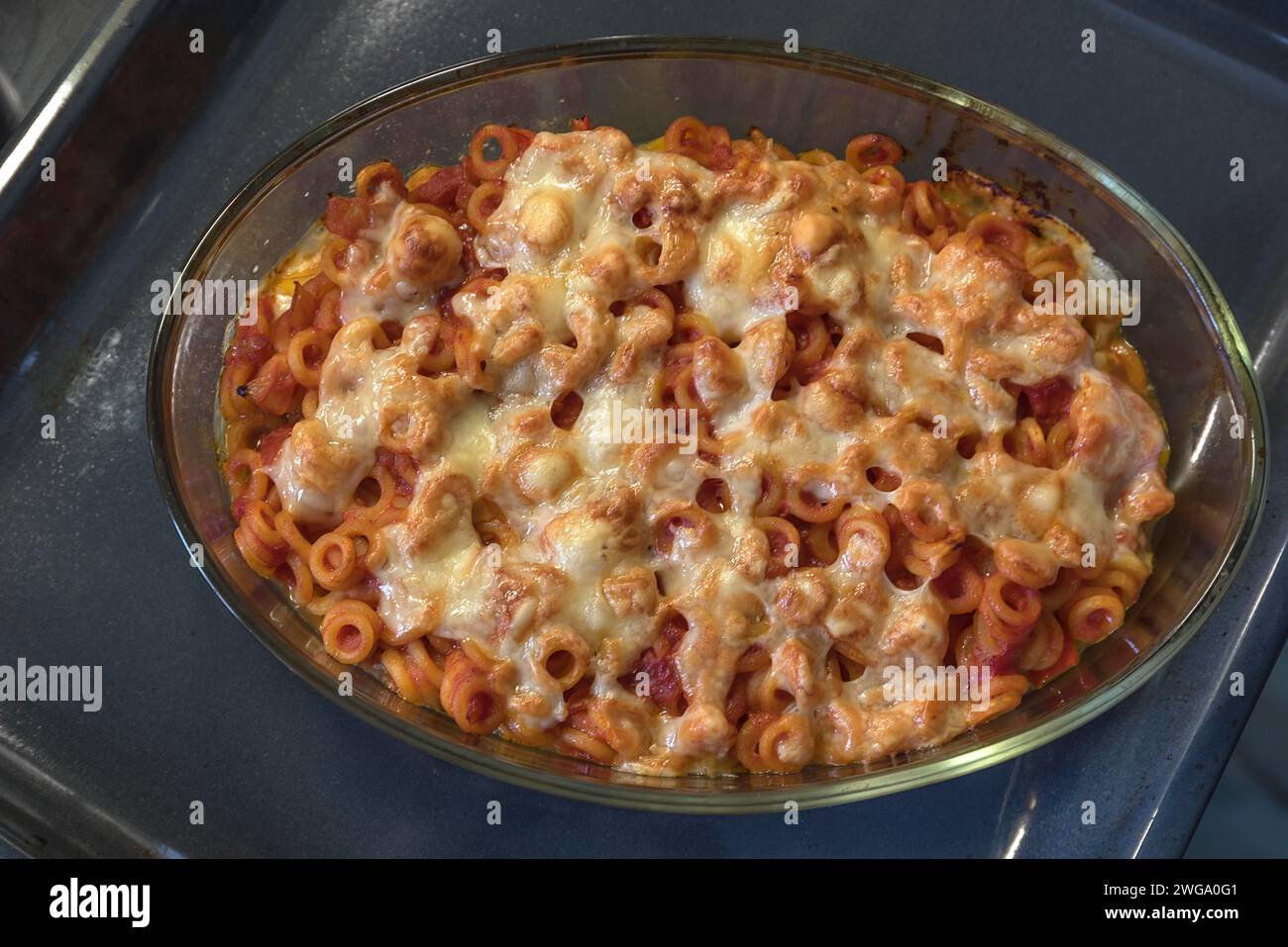 Pasta with tomatoes and cheese baked in a casserole dish in the oven, Franconia, Bavaria, Germany Stock Photo