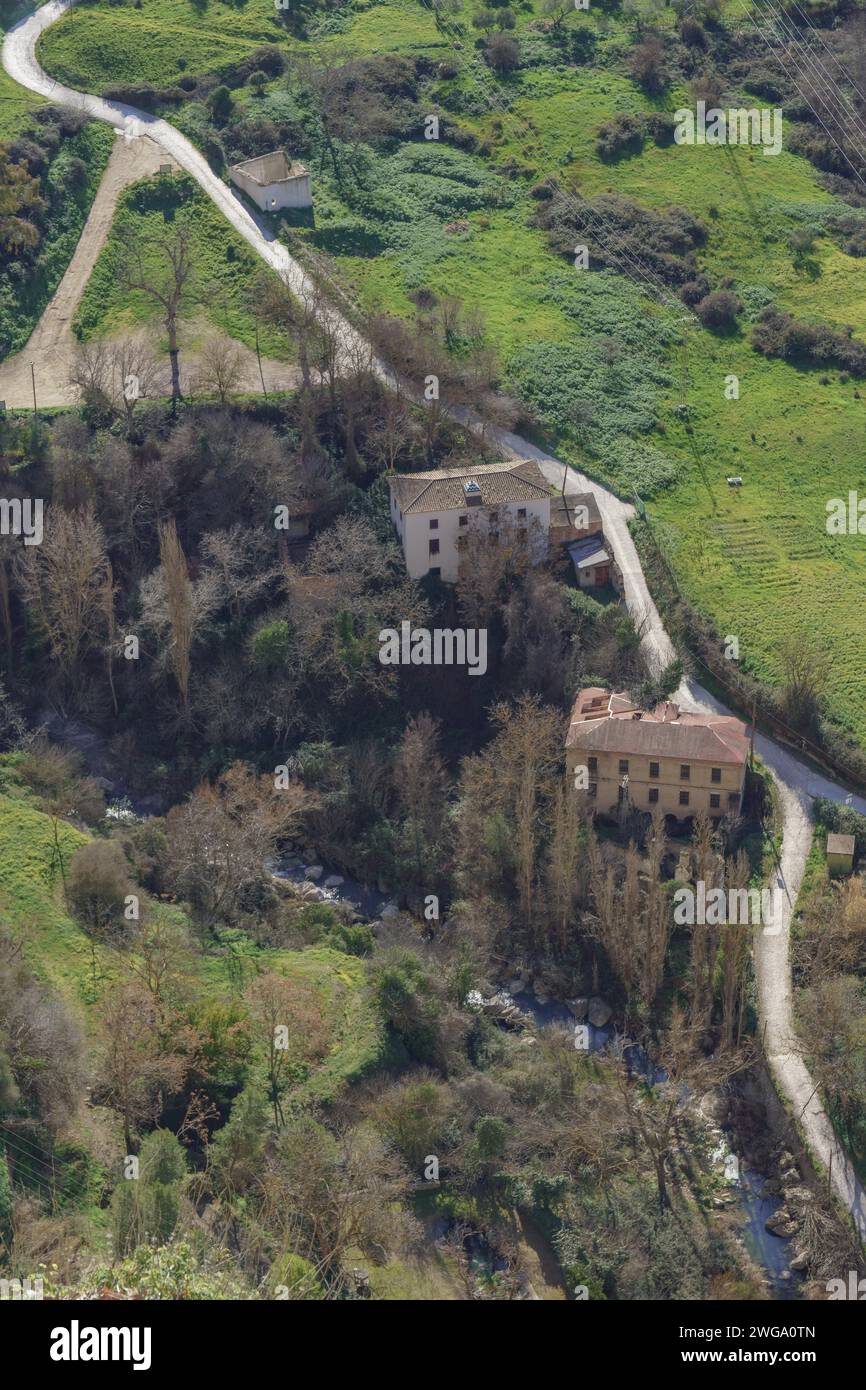 Aerial view of old flour mills on the bank of a river surrounded by a green landscape Stock Photo