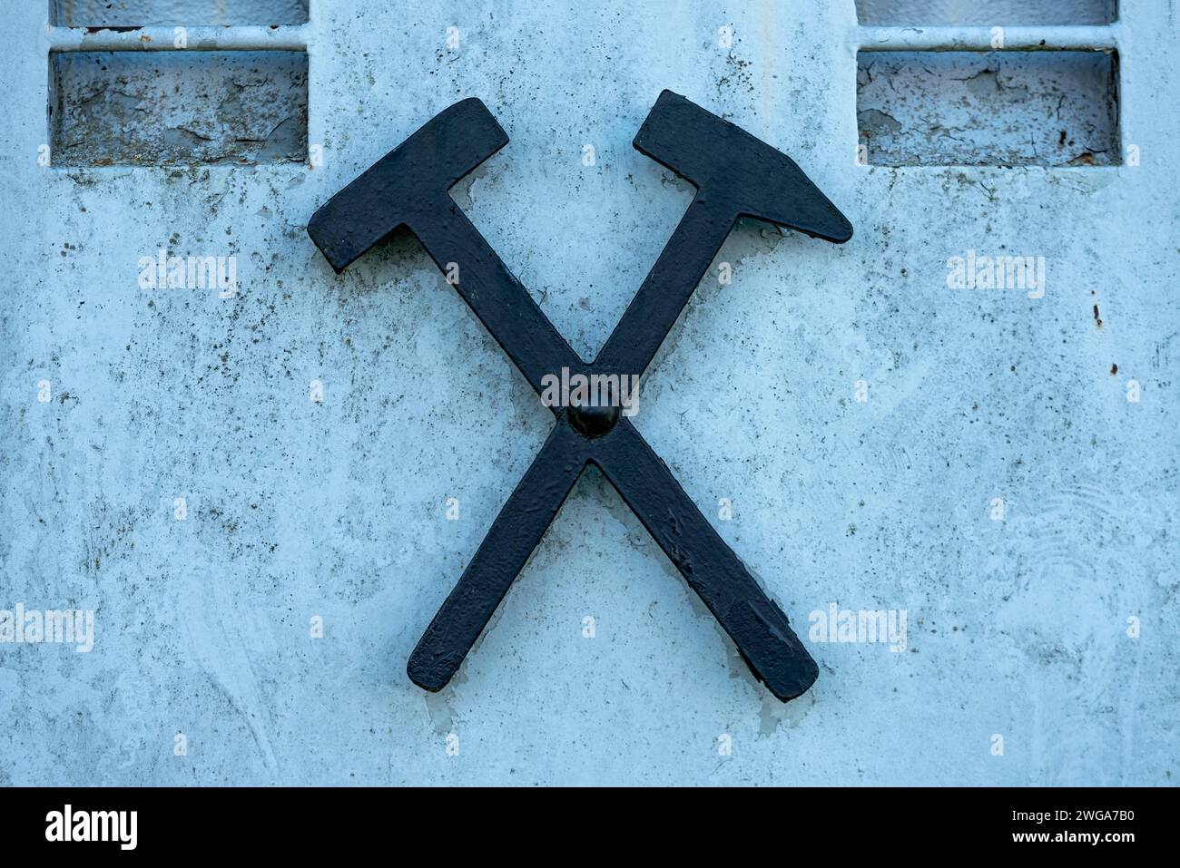 Mallet and chisel, mallet and iron, symbol of mining on a mine car, lorry for transporting lignite underground, open-air museum at Weckesheim Stock Photo