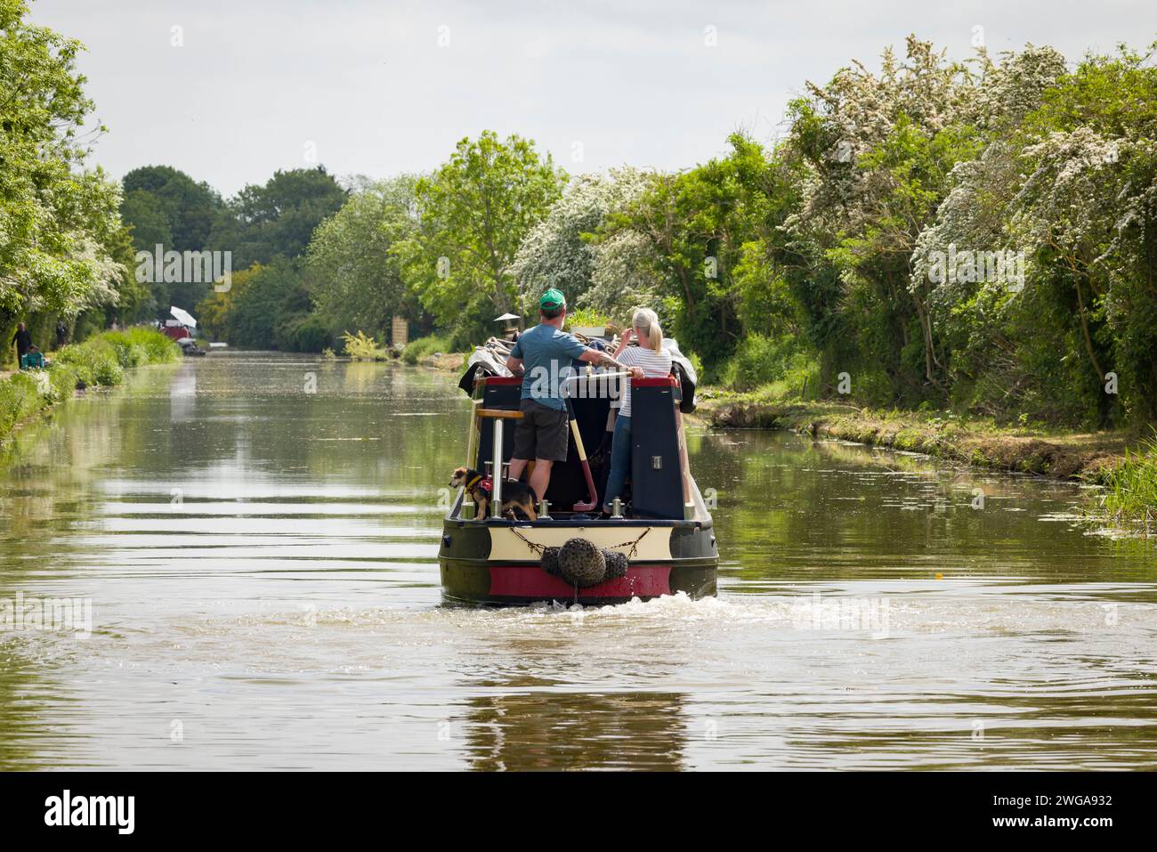 MILTON KEYNES, UK - May 25, 2023. Man and woman steer a narrowboat on the Grand Union Canal, Stony Stratford, Milton Keynes, UK Stock Photo