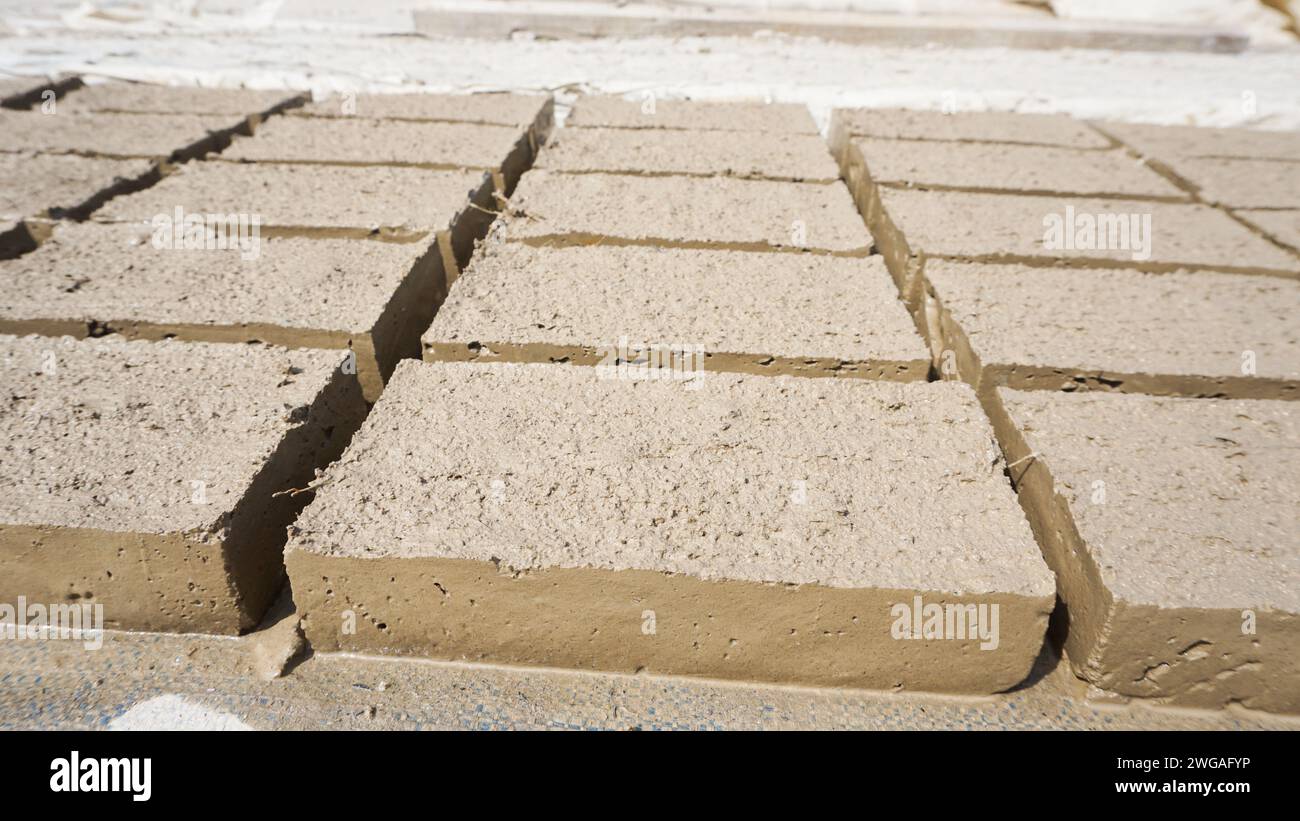 Raw traditional Indonesian bricks being dried in the sun Stock Photo