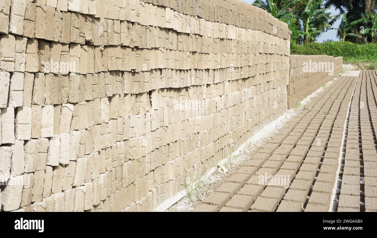 Raw traditional Indonesian bricks being dried in the sun Stock Photo