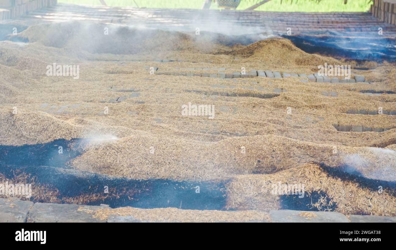 brick burning using dry husks somewhere in Indonesia Stock Photo