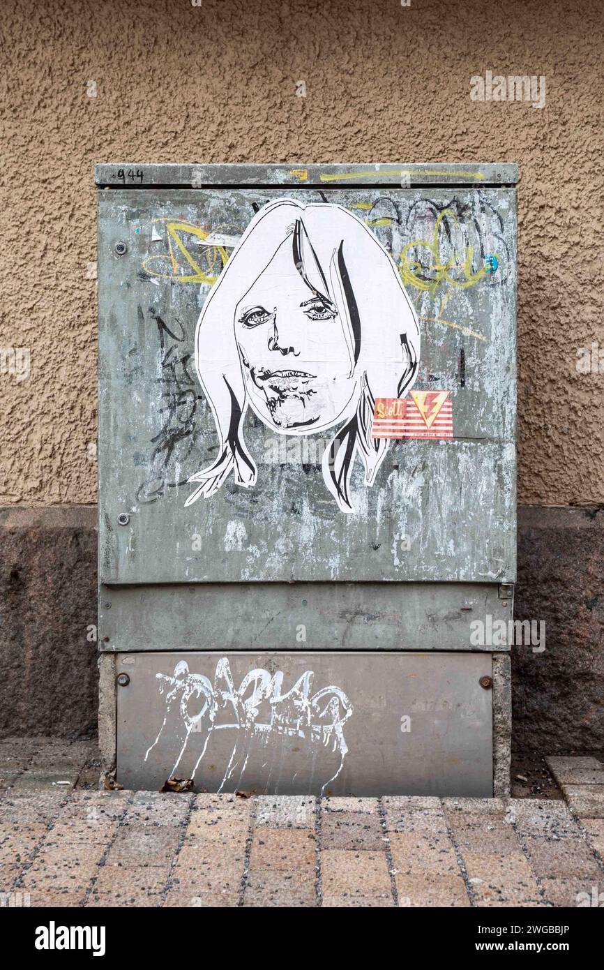 Scott Caris street art poster on a street cabinet in Helsinki, Finland Stock Photo