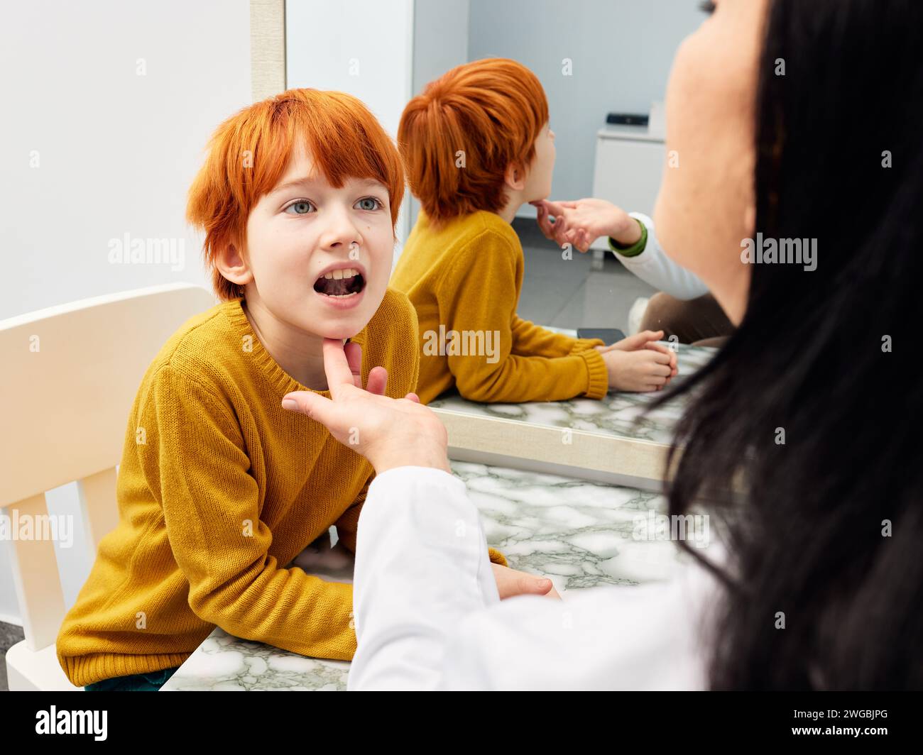 Male child in session with a speech therapist. Paediatric speech and language therapy Stock Photo