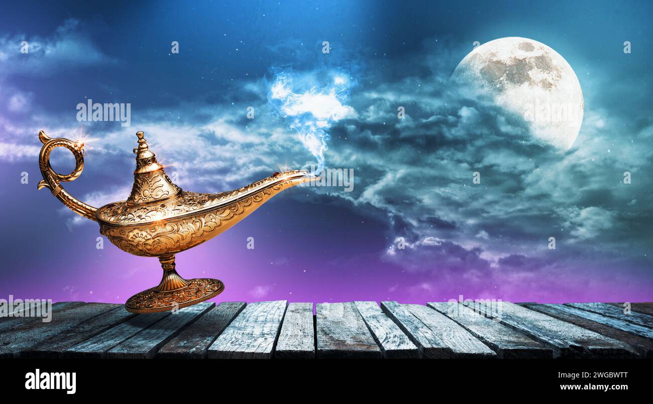 Golden magic lamp and night sky with full moon in the background Stock Photo