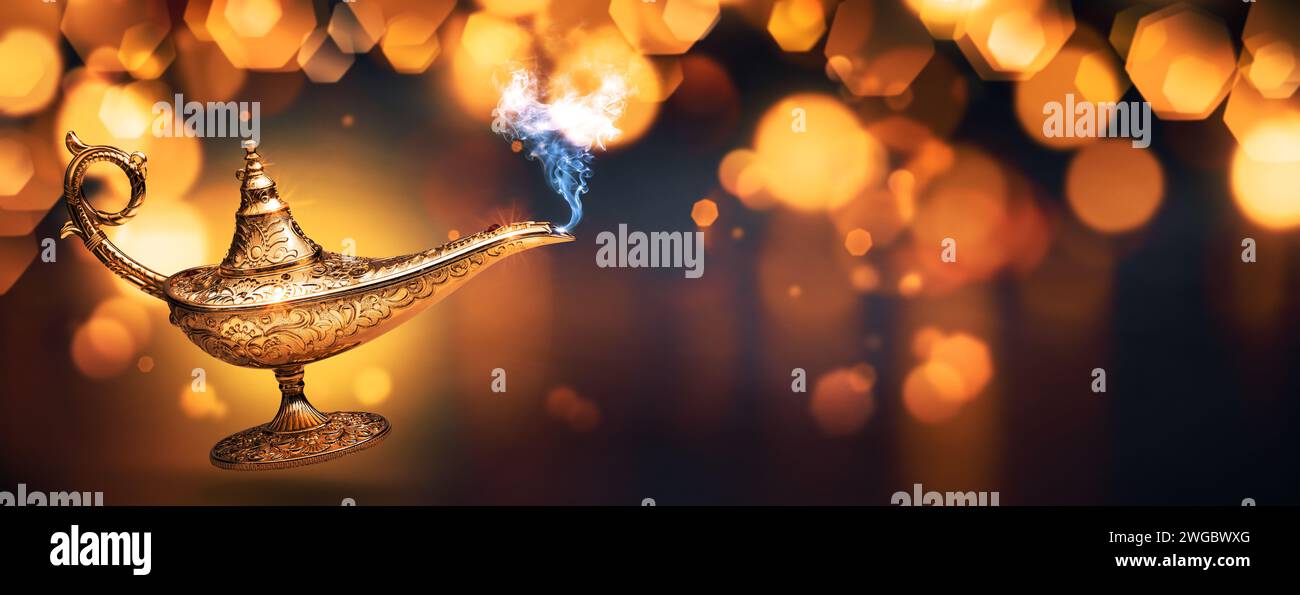Precious magic lamp with smoke and golden bokeh background, wish fulfillment and fantasy concept Stock Photo