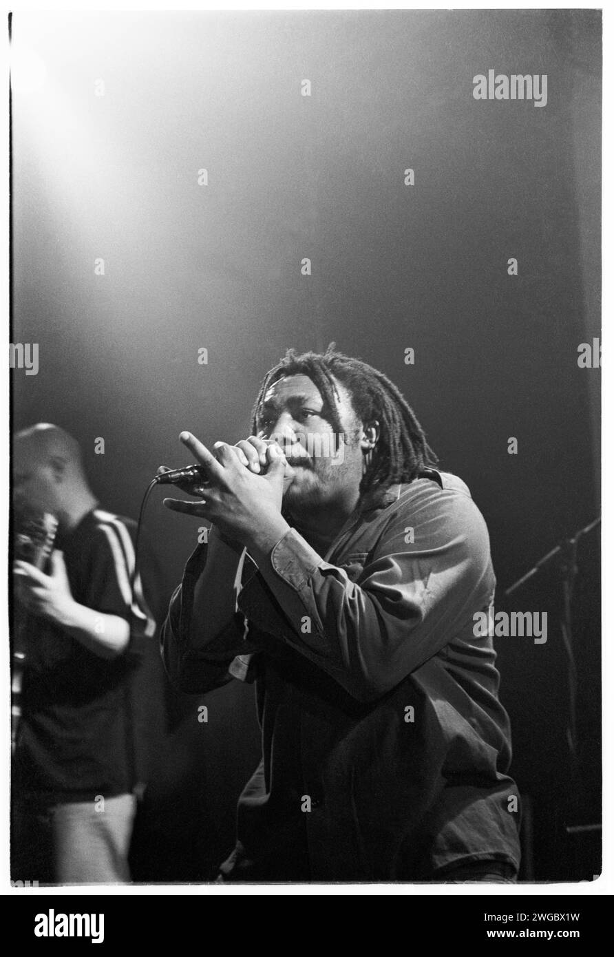BENJI WEBBE, DUB WAR, 1995: Benji Webbe of the Welsh metal reggae band Dub War playing a very early gig  at Cardiff University Terminal in Cardiff, Wales on 10 March 1995. Photo: Rob Watkins. INFO: Dub War, a British alternative metal band formed in 1993, blended reggae, punk, and metal. Albums like 'Pain' showcased their energetic and politically charged sound. Though short-lived, Dub War's fusion of genres left a mark on the '90s alternative and metal scenes. Stock Photo