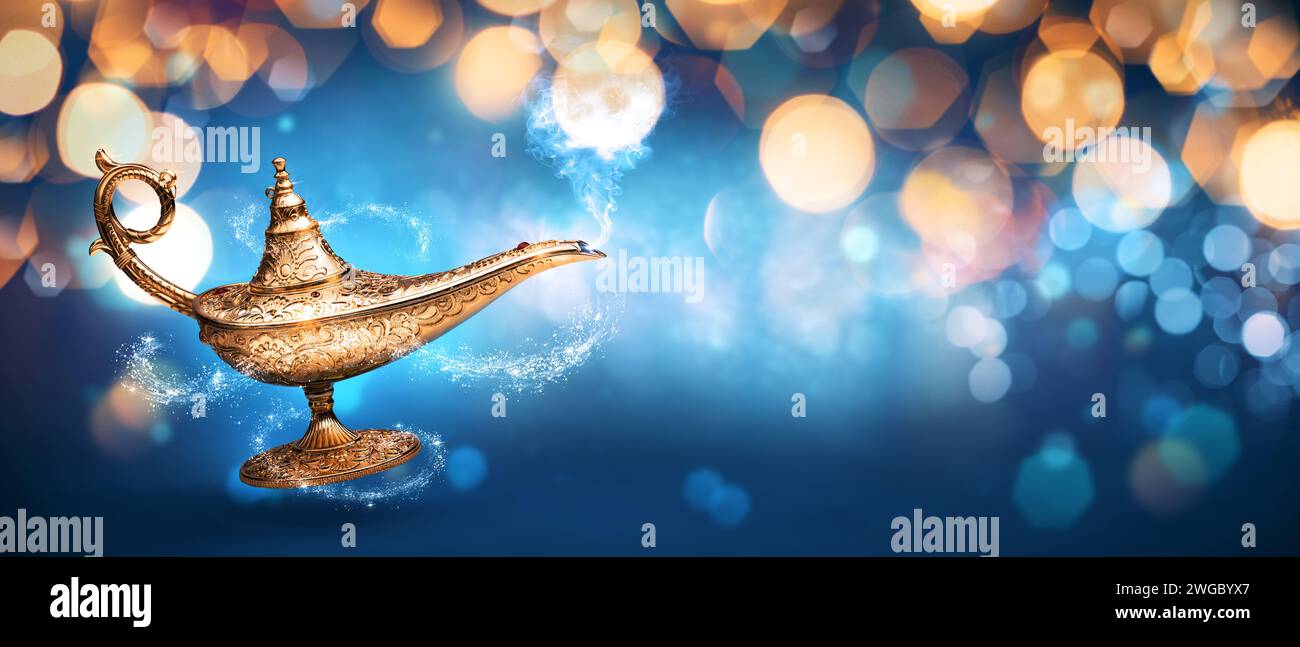 Precious magic lamp with smoke and golden bokeh background, wish fulfillment and fantasy concept Stock Photo