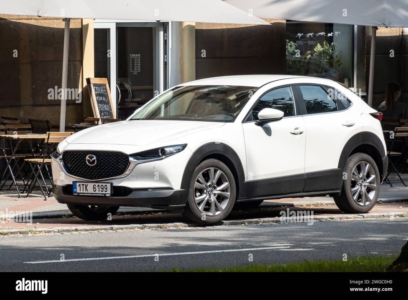 OSTRAVA, CZECH REPUBLIC - Mazda CX-30 compact crossover in white colour parking in front of restaurant Stock Photo