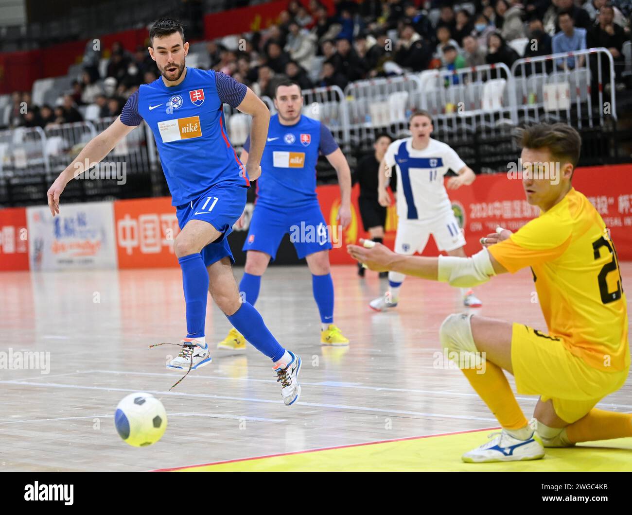 Xi'an, China's Shaanxi Province. 4th Feb, 2024. Slovakia's Gresko Robert (L) shoots during a match between Finland and Slovakia at the CFA 'Yulin Tourism Investment' Cup Futsal International Tournament 2024 in Xi'an, northwest China's Shaanxi Province, Feb. 4, 2024. Credit: Li Yibo/Xinhua/Alamy Live News Stock Photo