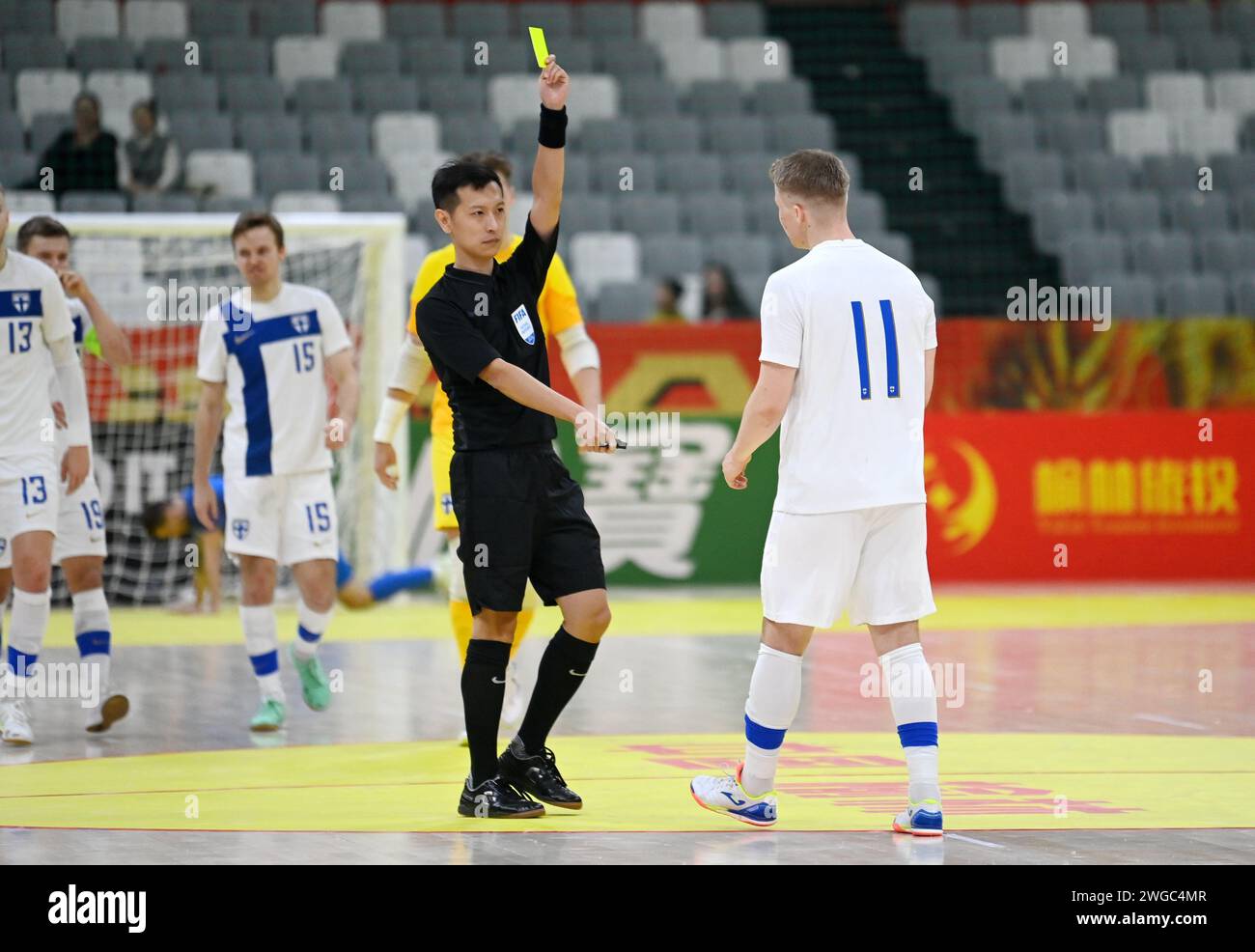 Xi'an, China's Shaanxi Province. 4th Feb, 2024. Referee Liu Jianqiao (L) shows a yellow card to Finland's Lassi Lintula during a match between Finland and Slovakia at the CFA 'Yulin Tourism Investment' Cup Futsal International Tournament 2024 in Xi'an, northwest China's Shaanxi Province, Feb. 4, 2024. Credit: Li Yibo/Xinhua/Alamy Live News Stock Photo