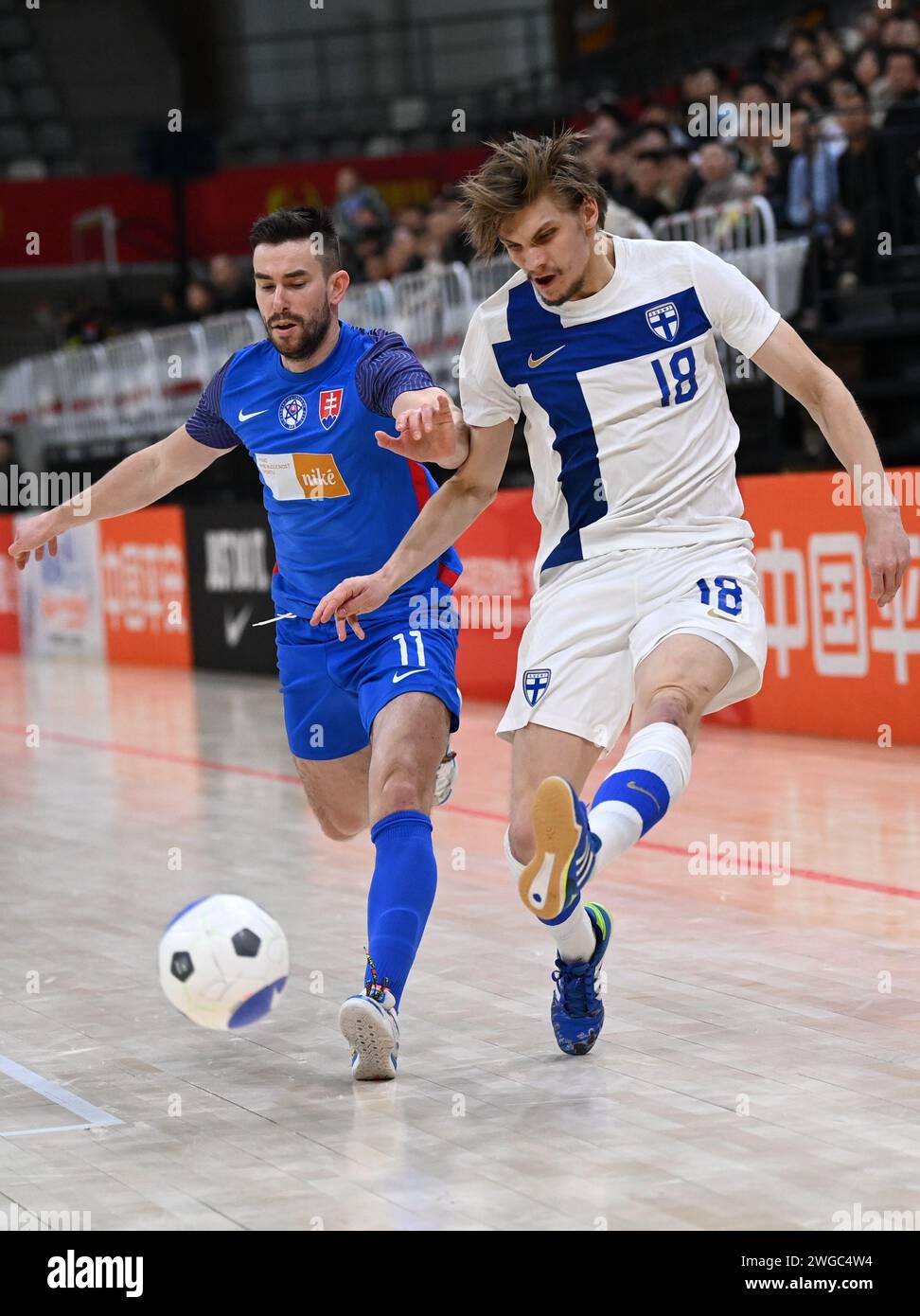 Xi'an, China's Shaanxi Province. 4th Feb, 2024. Finland's Jere Intala (R) vies with Slovakia's Gresko Robert during a match between Finland and Slovakia at the CFA 'Yulin Tourism Investment' Cup Futsal International Tournament 2024 in Xi'an, northwest China's Shaanxi Province, Feb. 4, 2024. Credit: Li Yibo/Xinhua/Alamy Live News Stock Photo