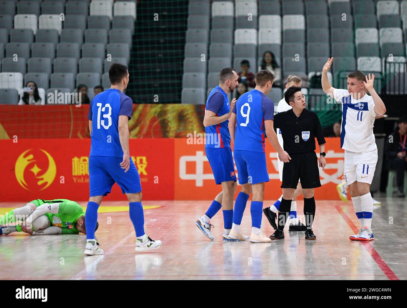 Xi'an, China's Shaanxi Province. 4th Feb, 2024. Finland's Lassi Lintula (1st R) reacts after making a foul during a match between Finland and Slovakia at the CFA 'Yulin Tourism Investment' Cup Futsal International Tournament 2024 in Xi'an, northwest China's Shaanxi Province, Feb. 4, 2024. Credit: Li Yibo/Xinhua/Alamy Live News Stock Photo