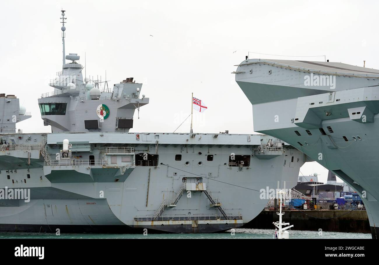 The Royal Navy aircraft carrier HMS Queen Elizabeth (left) alongside at
