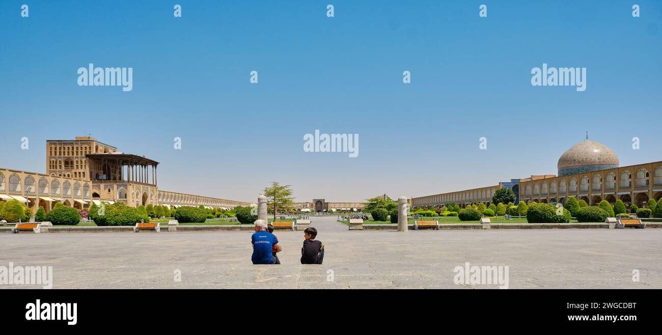 Isfahan, Iran, 06.30.2023: Naqsh-e Jahan Square, Grandfather and grandchild in Naqsh-e Jahan Square, esfehan, iran Stock Photo