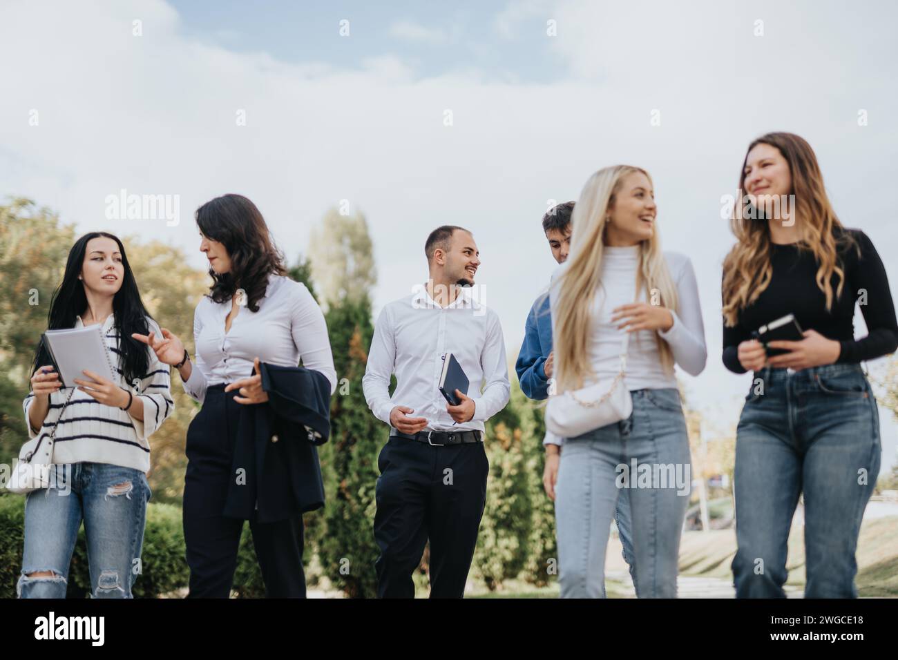 Students Collaborating Outdoors for Academic Success Stock Photo