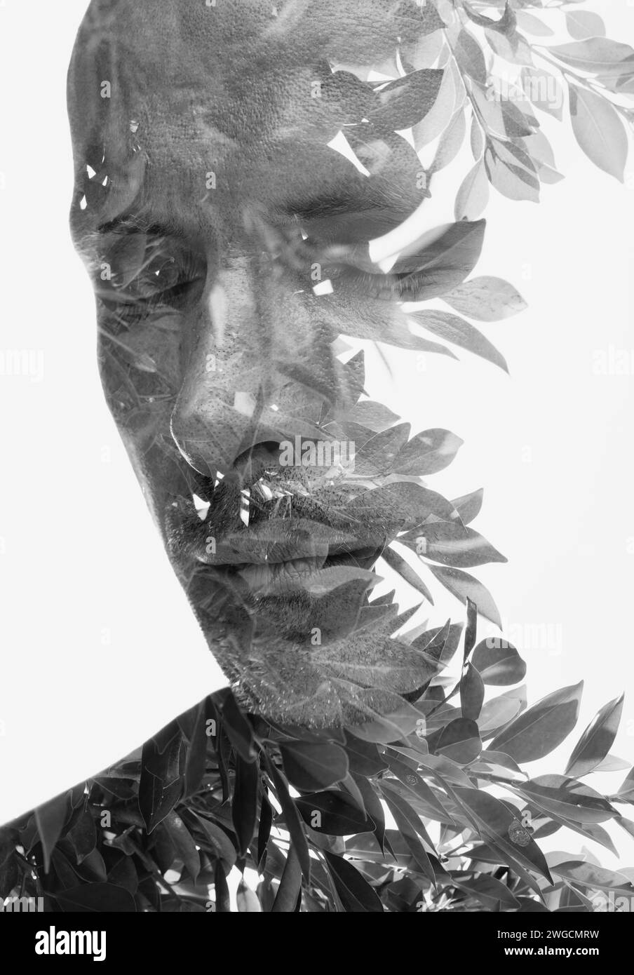 A black and white double exposure portrait of a man with closed eyes ...