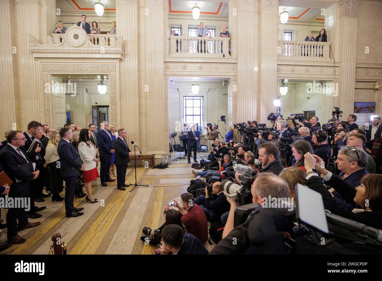 DUP leader Sir Jeffrey Donaldson MP at the microphone with party colleagues in the Great Hall at Parliament Buildings at Stormont speaks with media, before a sitting of the Northern Ireland Assembly where Sinn Fein Vice President Michelle O'Neill was named Northern Ireland's first nationalist first minister. A 'historic day' has been hailed as devolved government is expected to return in Northern Ireland. Picture date: Saturday February 3, 2024. Stock Photo