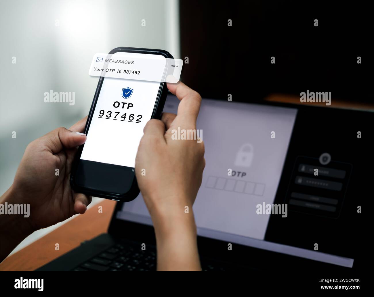 Two steps authentication concept. OTP code showing on phone screen for log in on web on laptop, validate password, Identity verification, cybersecurit Stock Photo