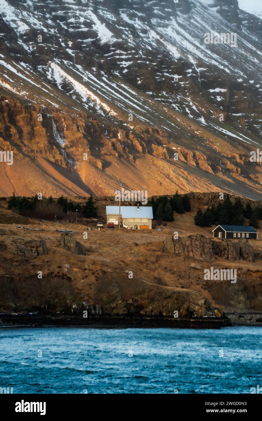 A typical Nordic house in front of mountains in southern Iceland Stock Photo