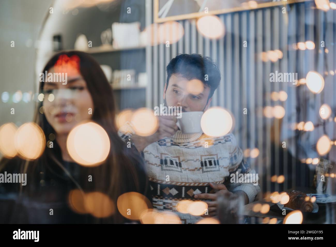 Young creative team engaging in idea generation in cozy cafe environment. Stock Photo