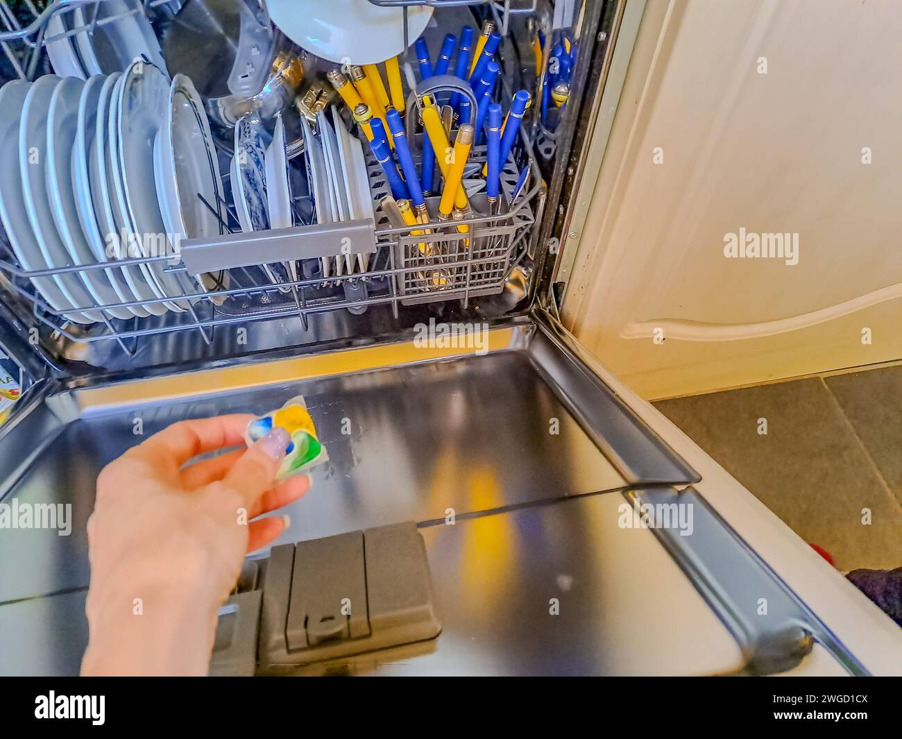 Person putting dishwasher tablet hi-res stock photography and images ...