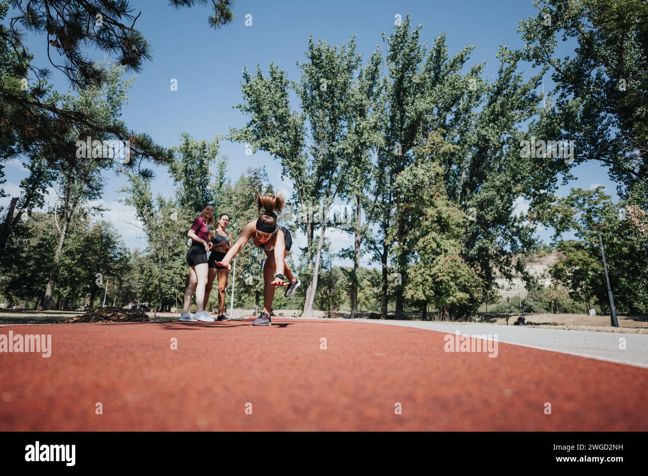 Athletic girls doing cartwheels in a sunny park, inspiring an active