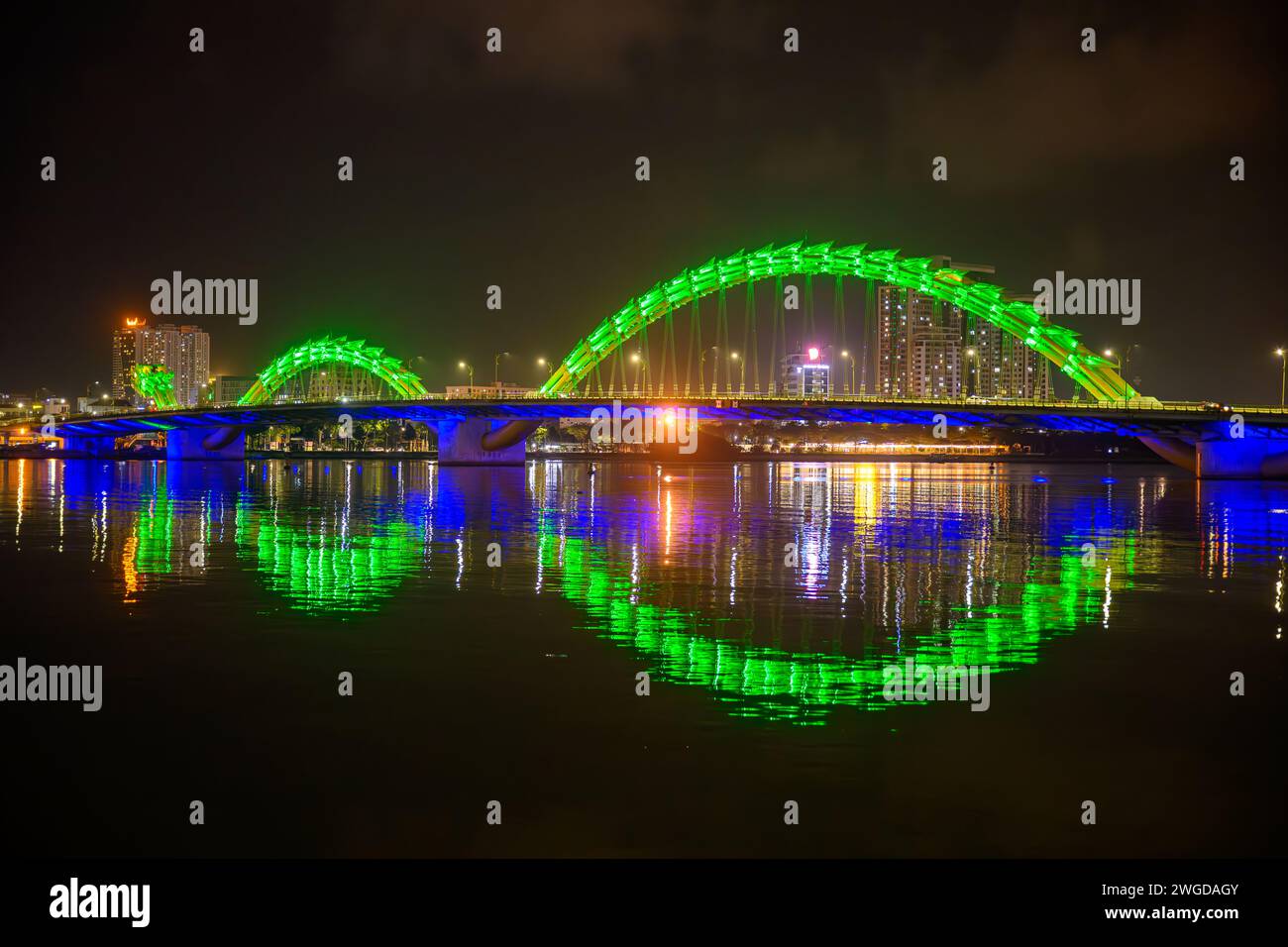 The Dragon Bridge at night with a reflection in the river,,Da Nang, Vietnam Stock Photo