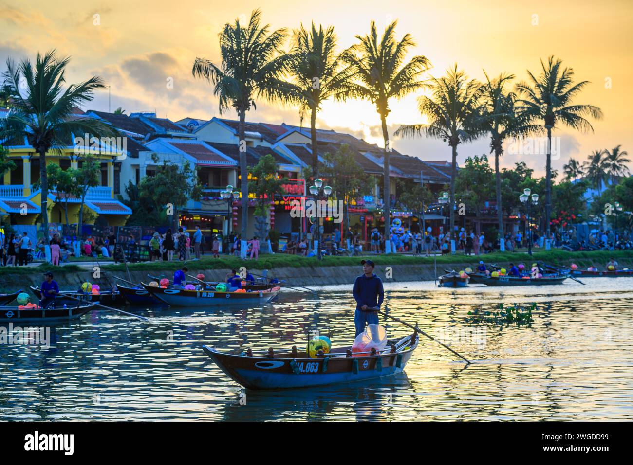 Tourist lantern boats at sunset on the Thu Bon River, Da Nang, Vietnam Stock Photo