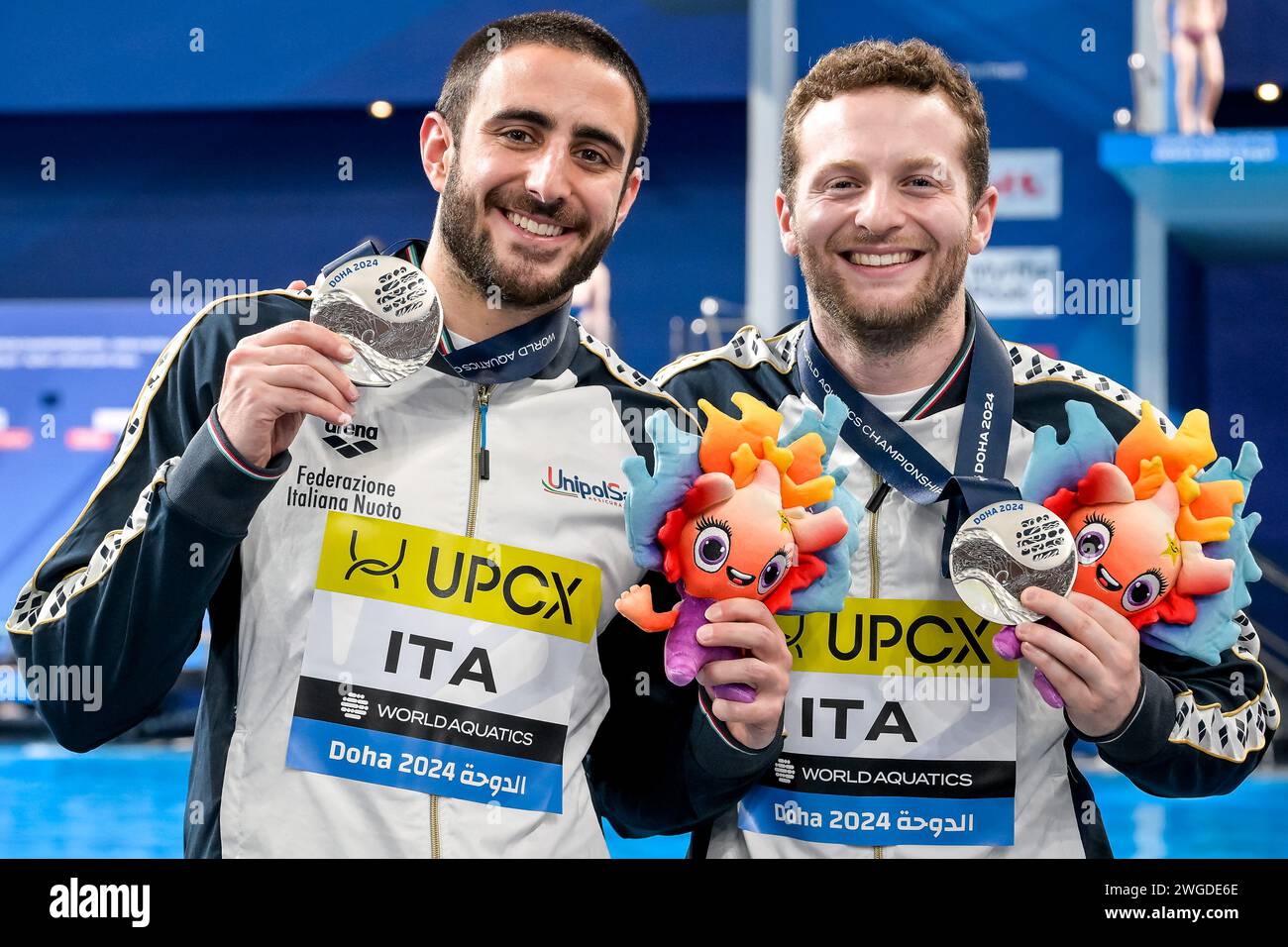 Lorenzo Marsaglia and Giovanni Tocci of Italy show the silver medal