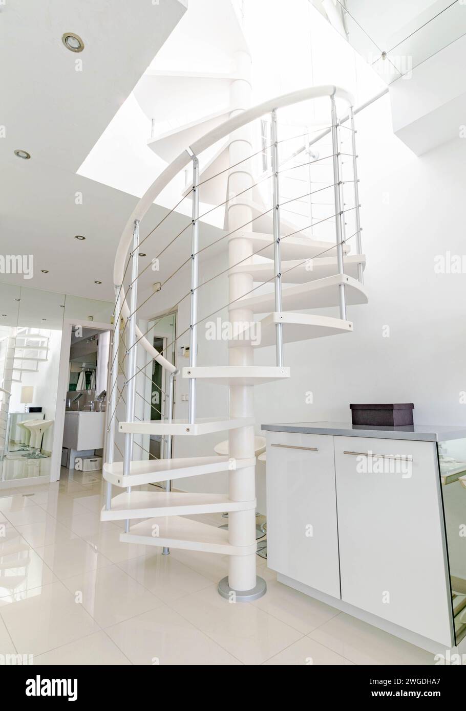 a portrait image of a spiral staircase in a luxury mediterranean studio ...