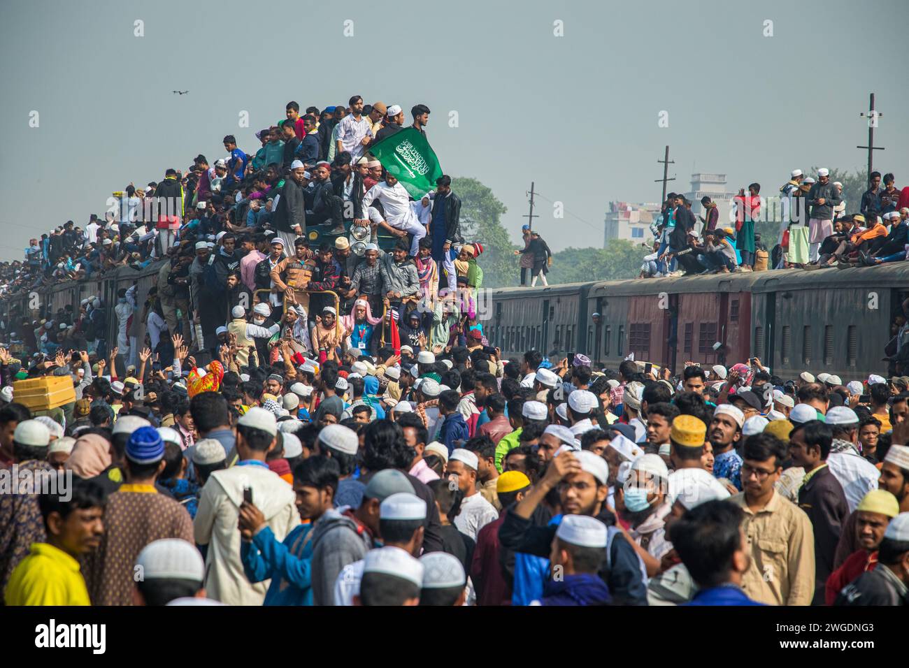 Embark on a brief but impactful ride atop the Ijtema train roof in Bangladesh, this image was captured on February 4, 2024, from Tonggi railway statio Stock Photo