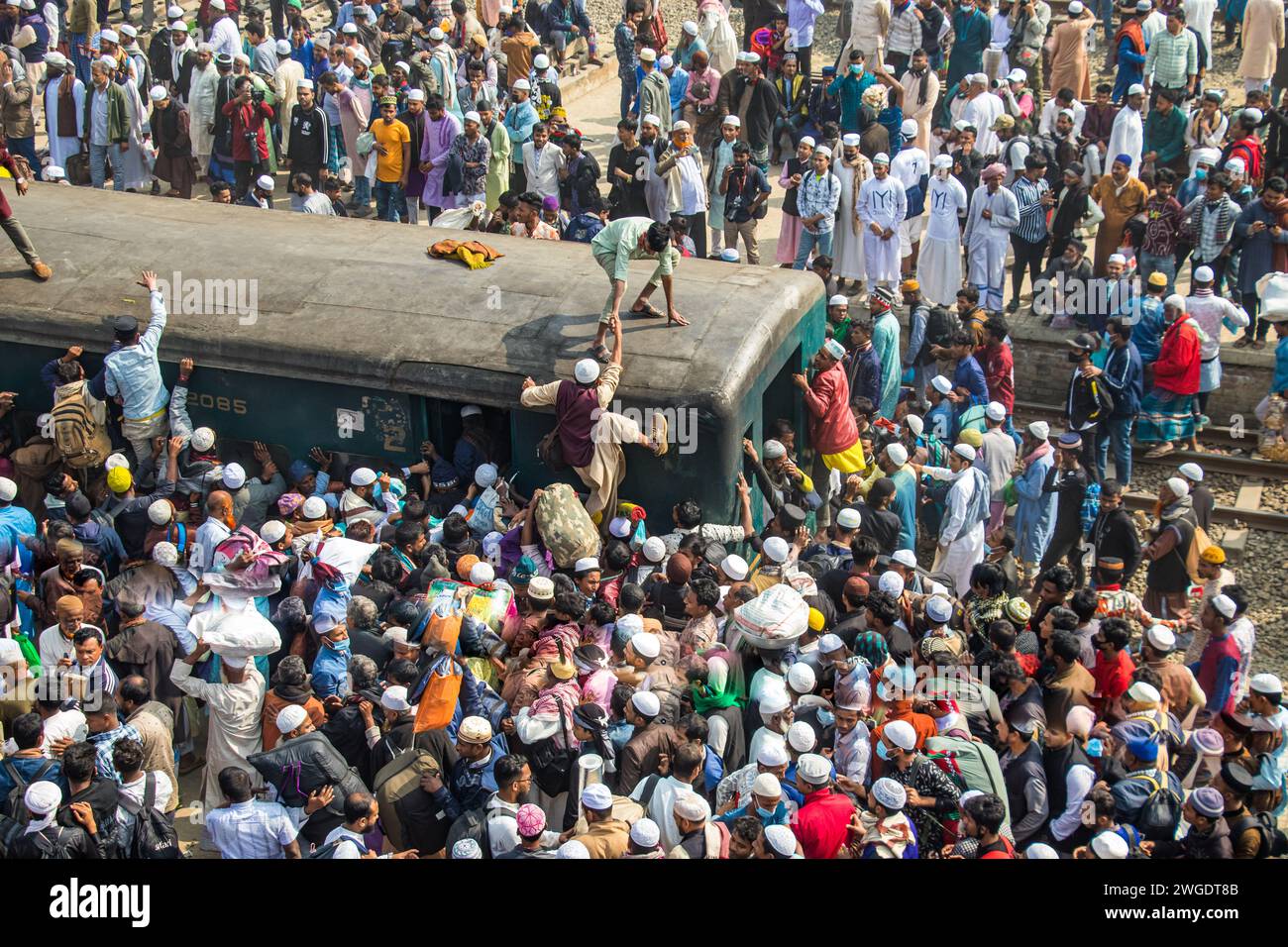 Embark on a brief but impactful ride atop the Ijtema train roof in Bangladesh, this image was captured on February 4, 2024, from Tonggi railway statio Stock Photo