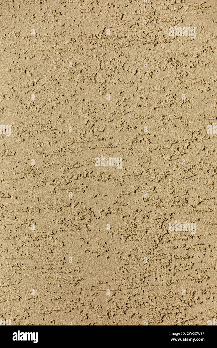 Beige background with abstract pattern. Wall covered with decorative plaster. Stock Photo