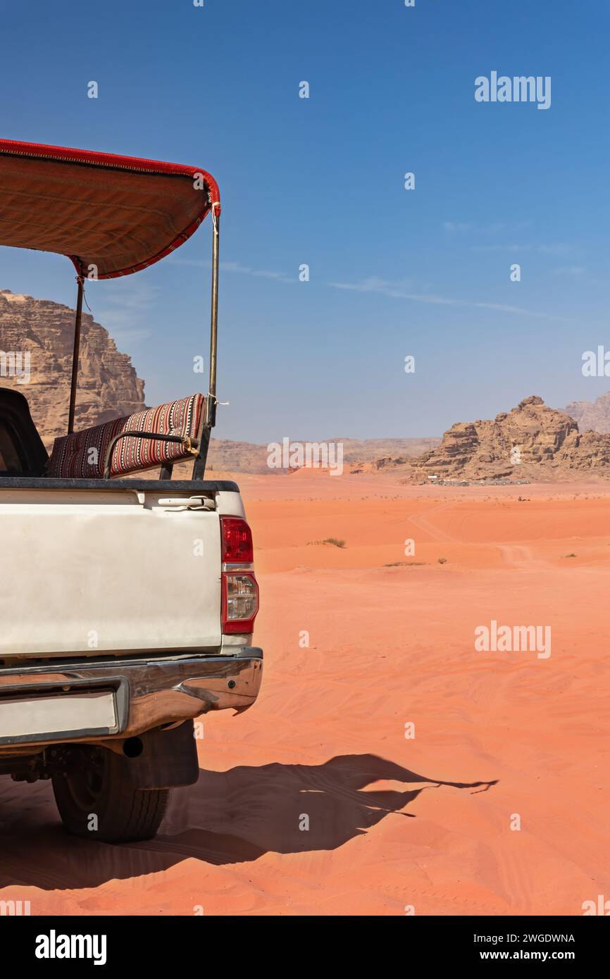 Empty SUV pickup car is ready to drive tourists for a drive through the desert in Wadi Rum. Jordan. Vertically. Stock Photo