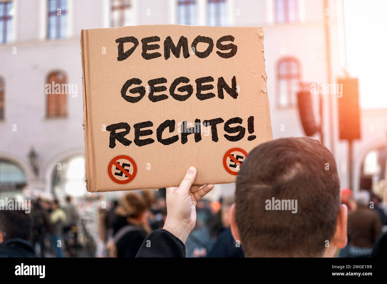 February 4, 2024: Demonstrations against the right, lettering together with a crossed-out swastika on a sign held by a demonstrator at a demonstration PHOTOMONTAGE *** Demos gegen Rechts, Schriftzug zusammen mit durchgestrichenem Hakenkreuz auf einem Schild das ein Demonstrant bei einer Demo in der Hand hält FOTOMONTAGE Stock Photo