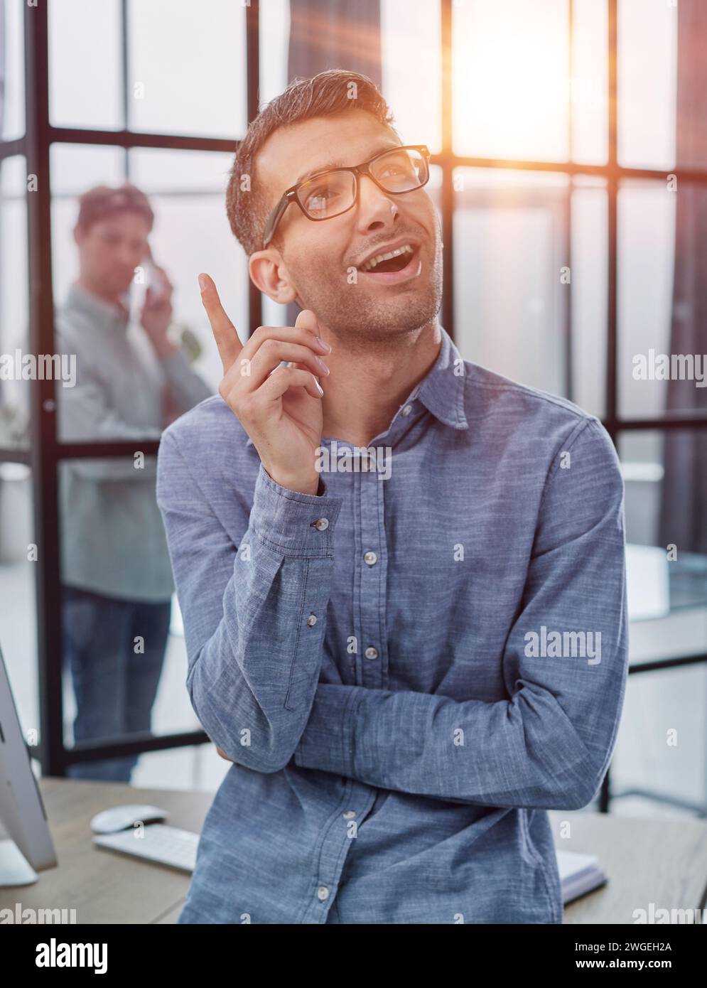 a man raised his finger up, came up with an idea how to make money, vertical shot Stock Photo