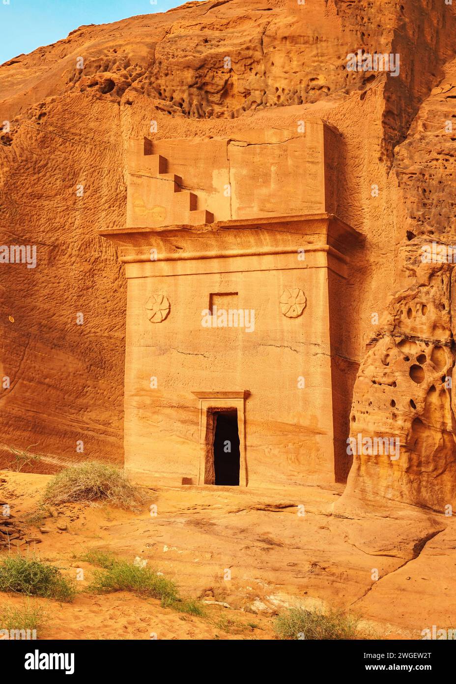 Old Nabatean architecture carved on orange sandstone wall at Jabal Al Ahmar, Hegra in Saudi Arabia, 18 ancient tombs are located here, 111 in whole Ma Stock Photo